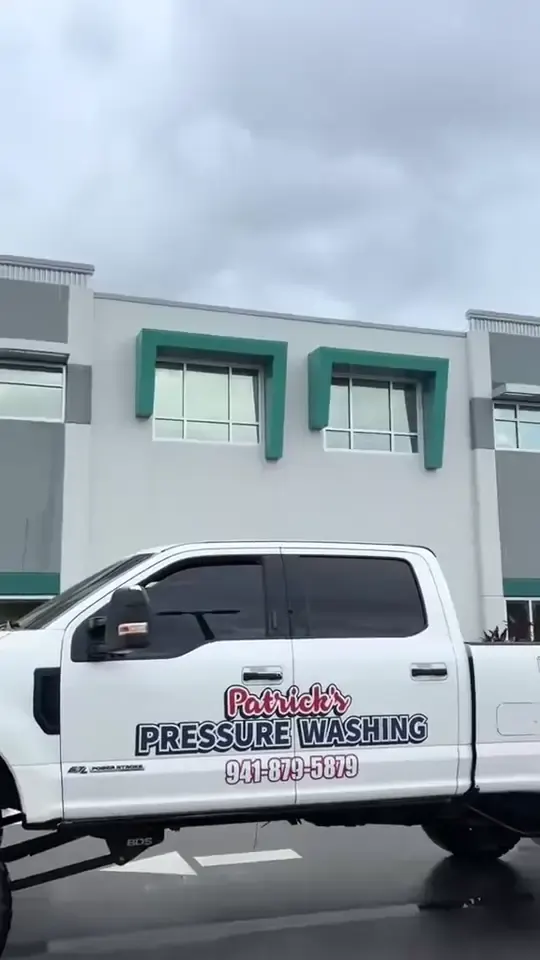 Washing a multi storey office building with a tracked boom lift.