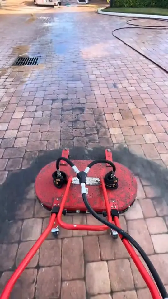 Surface cleaning brick pavers at a condo entrance, with sealer buckets ready.
