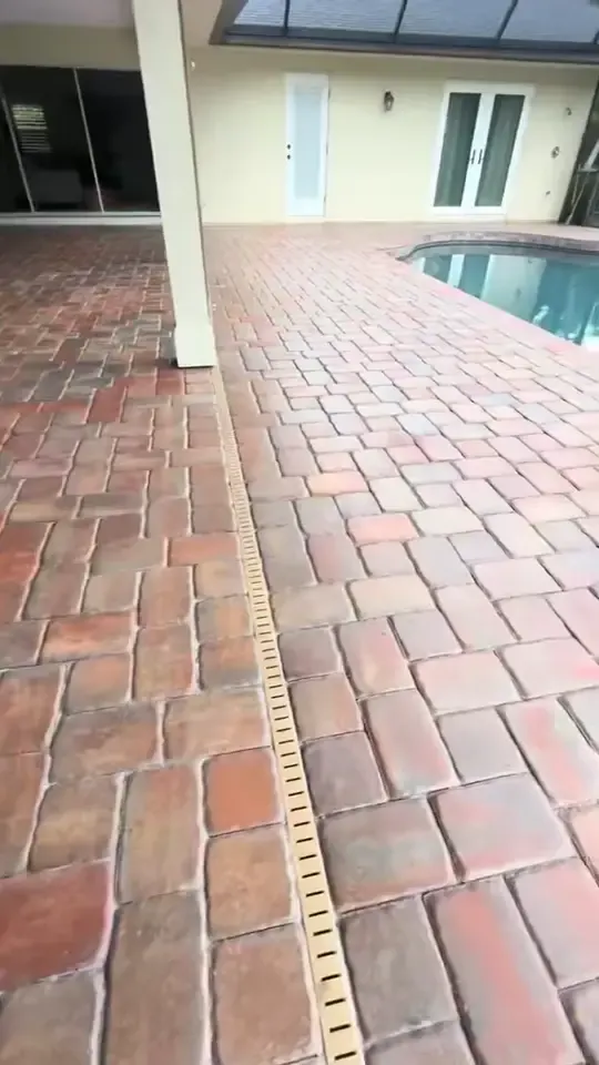 A paver pool deck cleaned, then a concrete driveway cleaned with a surface cleaner.