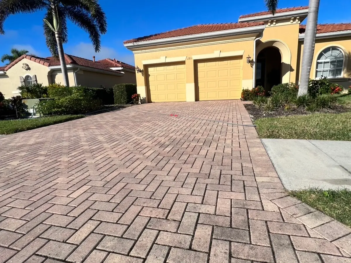 A brick paver driveway dull and gray with age